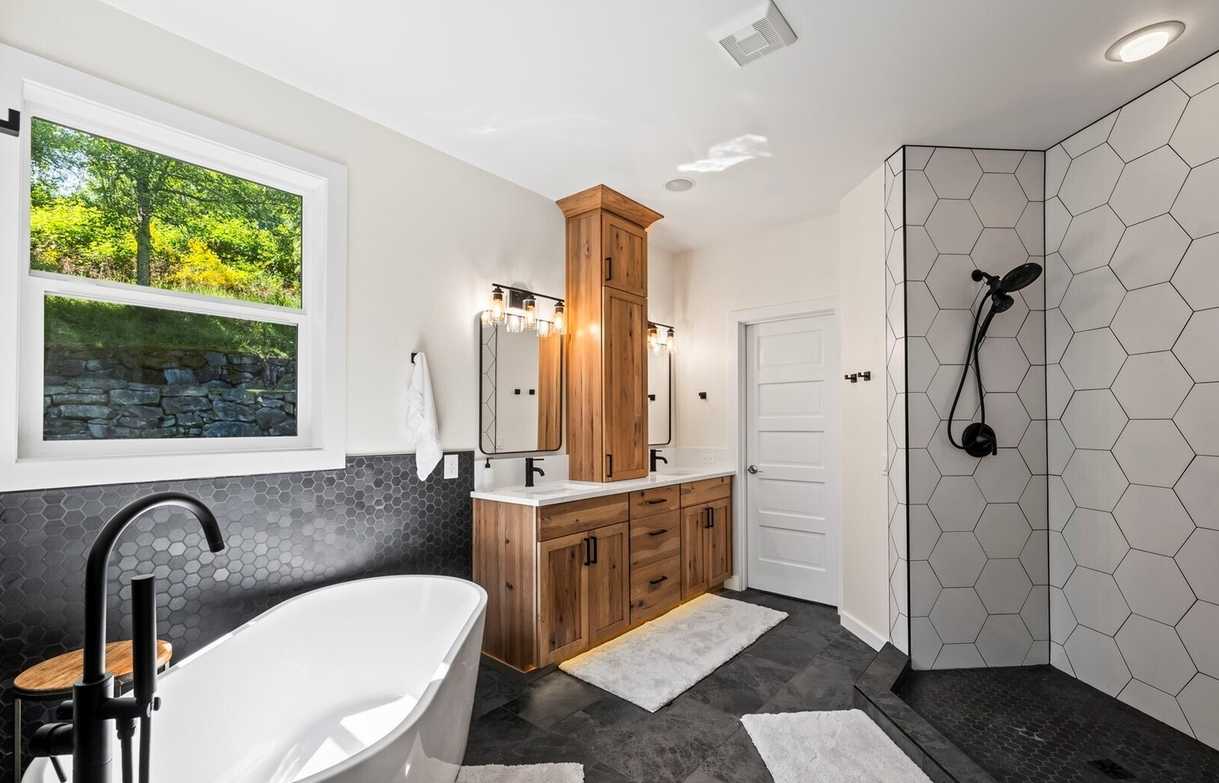 After photo form Tacoma bathroom remodel project featuring modern tile, new vanity, soaker tub